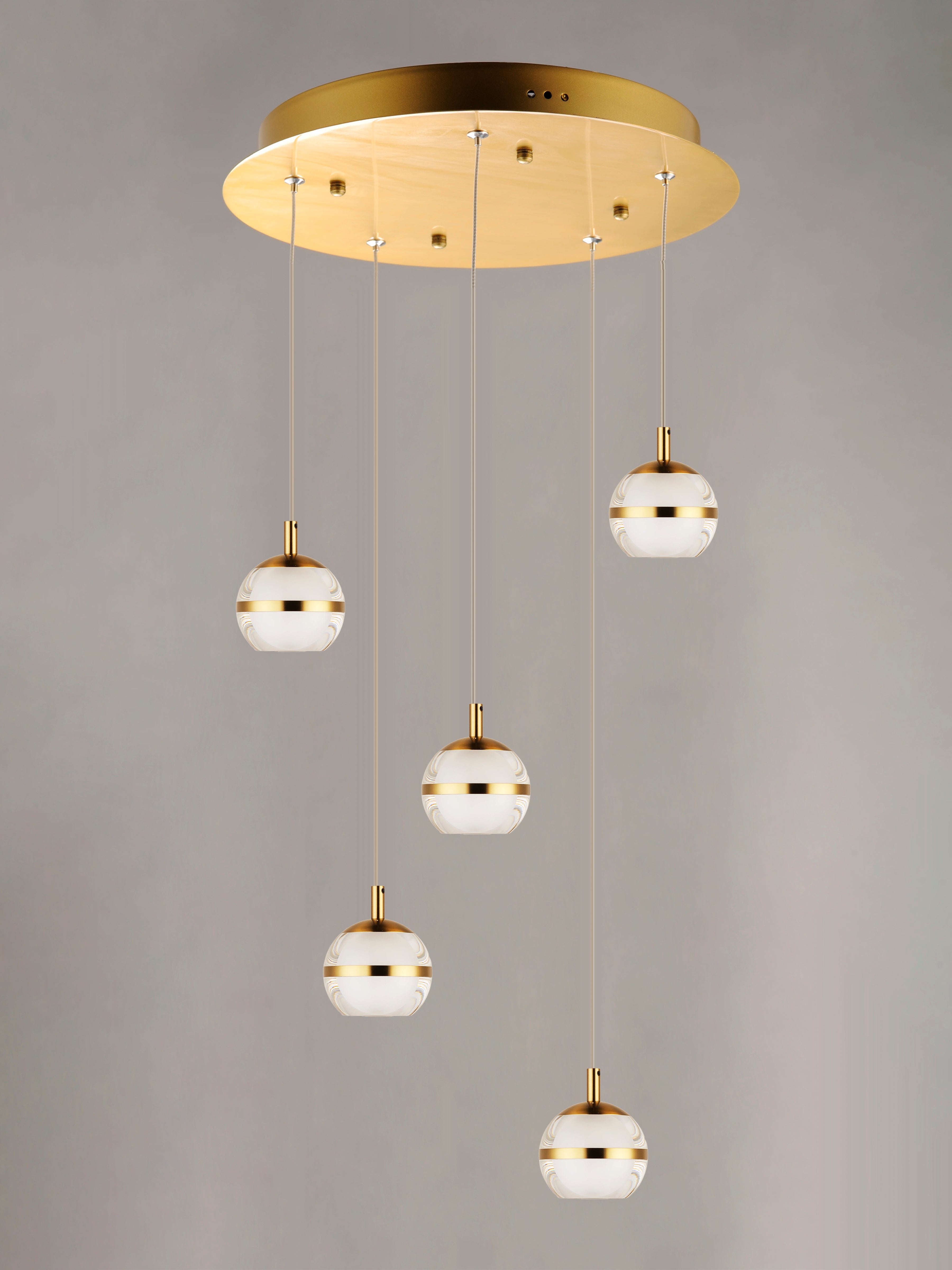 Modern pendant light fixture with gold and white design on a gray background