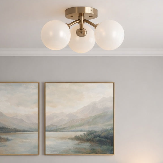 Novo 3 light, glass globe modern flush mount in Aged Gold Brass by Matteo